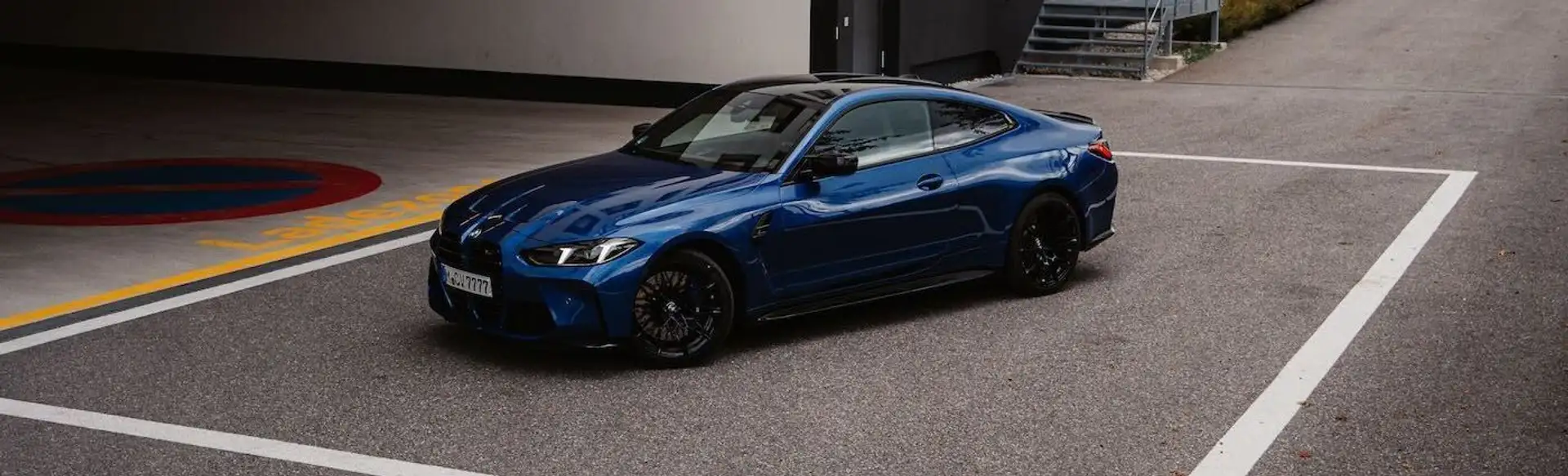 The front view of our BMW M4 Competition in a driveway.
